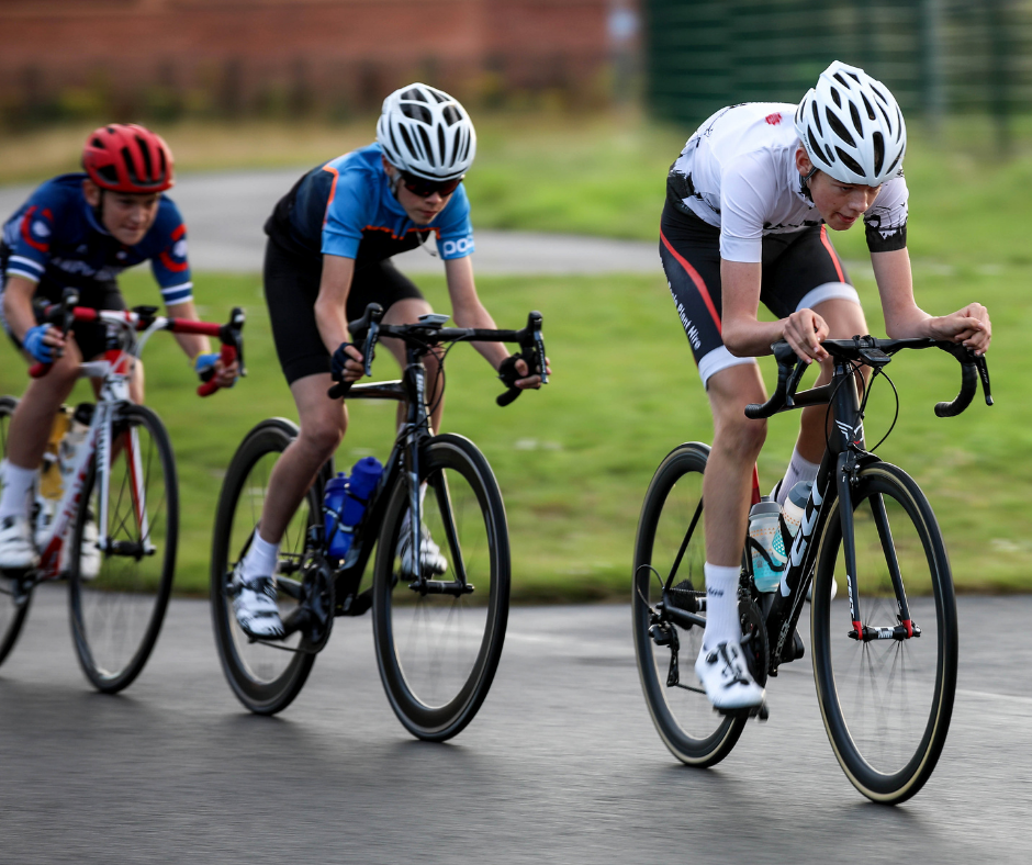 3 young racers cycling fast.